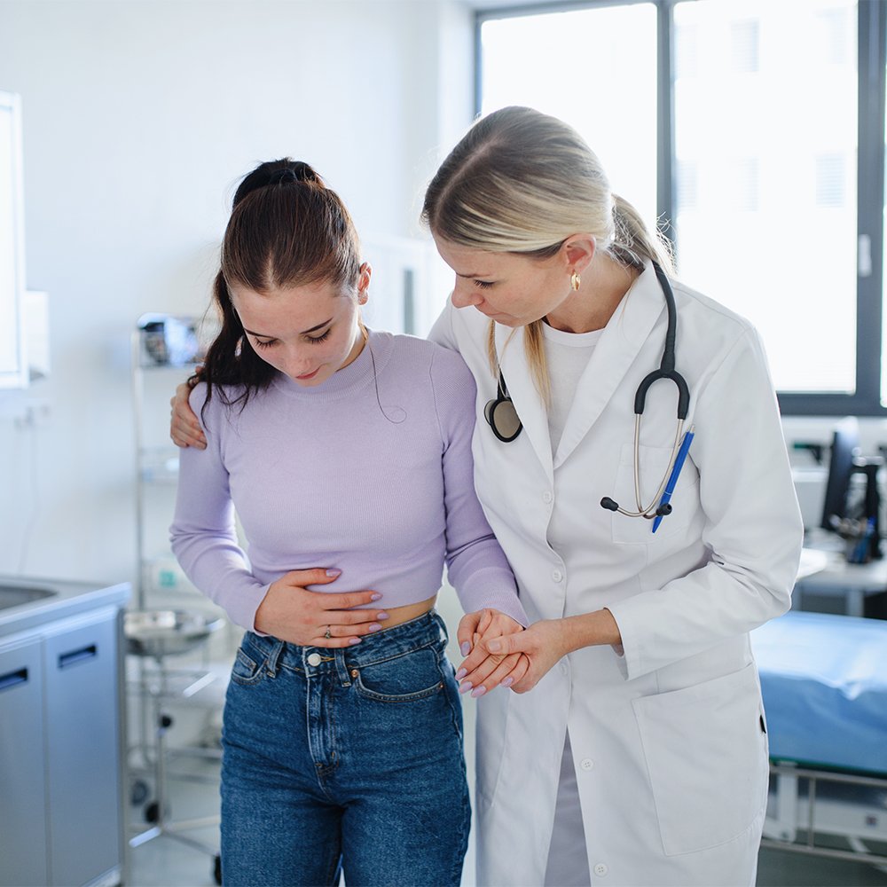 doctor helping patient with stomach pain